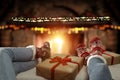 Christmas time, legs in winter socks. Space for your text or decoration. Old fireplace wall background. Royalty Free Stock Photo