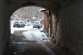 Winter city. Dark arch to the courtyard of an old house. Cars are parked in the arched courtyard of the well. Rybinsk, Russia Royalty Free Stock Photo