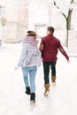 Winter city love. Happy young couple in warm sweaters having fun in winter city. Winter morning, christmas and holiday Royalty Free Stock Photo