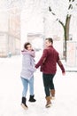 Winter city love. Happy young couple in warm sweaters having fun in winter city. Winter morning, christmas and holiday Royalty Free Stock Photo