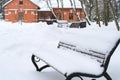 Winter in the city park. Benches in the snow, selective focus Royalty Free Stock Photo