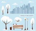 Winter city park elements. Urban outdoor decor: bench, lamps, trash box, trees and bushes, city silhouette. For construction of