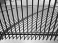 Winter cityscape. Fence and shade from the sun. Black and white photography