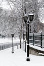 Winter cityscape with a lamppost covered in snow