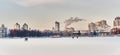 Winter cityscape of Yekaterinburg, Russia. Ice of city pond covered in snow, buildings, people. Royalty Free Stock Photo