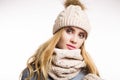 Winter close-up portrait of attractive young blonde woman wearing beige warm knitted hat with fur pompom and scarf Royalty Free Stock Photo