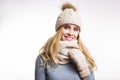 Winter close-up portrait of attractive young blonde woman wearing beige warm knitted hat with fur pompom and scarf snood. Girl Royalty Free Stock Photo