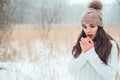 winter close up portrait of beautiful young woman in knitted hat and sweater walking outdoor Royalty Free Stock Photo