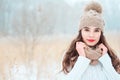 Winter close up portrait of beautiful young woman in knitted hat and sweater walking outdoor Royalty Free Stock Photo