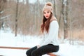 Winter close up portrait of beautiful young woman in knitted hat and sweater walking outdoor