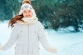 Winter close up portrait of cute dreamy child girl in white coat, hat and mittens