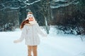 Winter close up portrait of cute dreamy child girl in white coat, hat and mittens