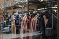 Winter clothes coats on hangers in a store on a showcase