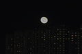 winter cloudless night view of the city - full moon over high-rise buildings Royalty Free Stock Photo