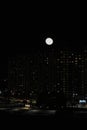 winter cloudless night view of the city - full moon over high-rise buildings Royalty Free Stock Photo