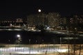 winter cloudless night view of the city - full moon over high-rise buildings Royalty Free Stock Photo