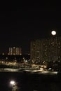 winter cloudless night view of the city - full moon over high-rise buildings Royalty Free Stock Photo