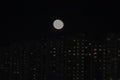 winter cloudless night view of the city - full moon over high-rise buildings Royalty Free Stock Photo