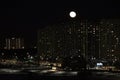 winter cloudless night view of the city - full moon over high-rise buildings Royalty Free Stock Photo