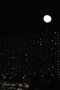 winter cloudless night view of the city - full moon over high-rise buildings Royalty Free Stock Photo