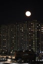 winter cloudless night view of the city - full moon over high-rise buildings Royalty Free Stock Photo