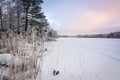 Winter cloudy sunset over the frozen lake Royalty Free Stock Photo