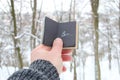 Winter or cold idea. Hand holding a book with the inscription Brr the background of the forest Royalty Free Stock Photo