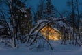 Winter cold night Landscape, small wooden house with warm light Royalty Free Stock Photo