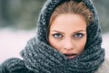 Young and blond girl wearing blue scarf in winter Royalty Free Stock Photo