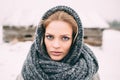 Young and blond girl wearing blue scarf in winter Royalty Free Stock Photo