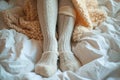 Winter comfort legs in leggings and wool socks peeking from blanket