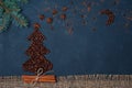 Winter composition Christmas tree made by coffee beans with night sky by anise star and chocolate. Greeting card New Year.