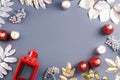 Winter concept flat lay with golden and silver leaves and red candles with snow falling. Christmas frame background Royalty Free Stock Photo