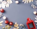 Winter concept flat lay with golden and silver leaves and red candles with snow falling. Christmas frame background Royalty Free Stock Photo