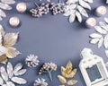 Winter concept flat lay with golden and silver leaves, white lantern with snow falling. Christmas frame background Royalty Free Stock Photo