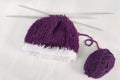 Winter concept: purple bonnet & knitting needles