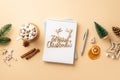 Winter concept. Top view photo of notepad merry christmas wooden text pen wood ornaments fir branch pine cone cup of cocoa with Royalty Free Stock Photo