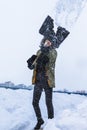 Winter Concepts. Workaholic Caucasian Handsome Man in Winter Outfit Throwing Away Snow With Broken Shovel In City Environment