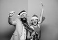 Winter corporate party. Office christmas party. Happy man and woman wear santa hats and funny sunglasses. Manager tinsel Royalty Free Stock Photo