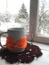 Winter cosiness: white ceramic mug of tea or coffee