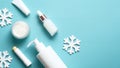 Winter cosmetic products set with snowflakes on pastel blue background. Skin care concept. Flat lay, top view Royalty Free Stock Photo