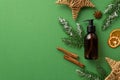 Winter cosmetics concept. Top view photo of amber glass bottle spruce branches in hoarfrost christmas decor wicker stars anise