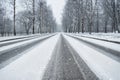 Winter country road in snowfall. Wheel tracks on a snowy road Royalty Free Stock Photo