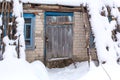 Winter countryside landscape, dilapidated abandoned ruined building covered in snow