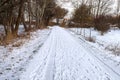 Winter countryside path with human footprints and sunlight. Royalty Free Stock Photo