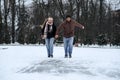 Winter couple activities. Winter Date Ideas to Cozy Up. Cold season dates for couples. Young couple in love waking Royalty Free Stock Photo