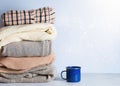 Winter cozy and casual clothes stack close up on on white background