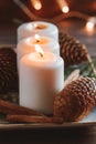 Winter cozy decoration with white burning candles on a wooden festive table and blurrred lights Royalty Free Stock Photo