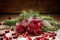 Winter cranberry sauce in glass jars with fresh cranberries, dec