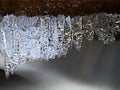 Winter creek with icicles above freeze mountain stream. Winter season Royalty Free Stock Photo